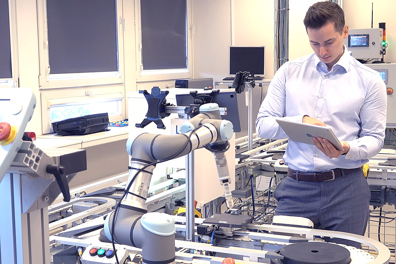 Engineer using a tablet during CORE OEE system implementation on a production line